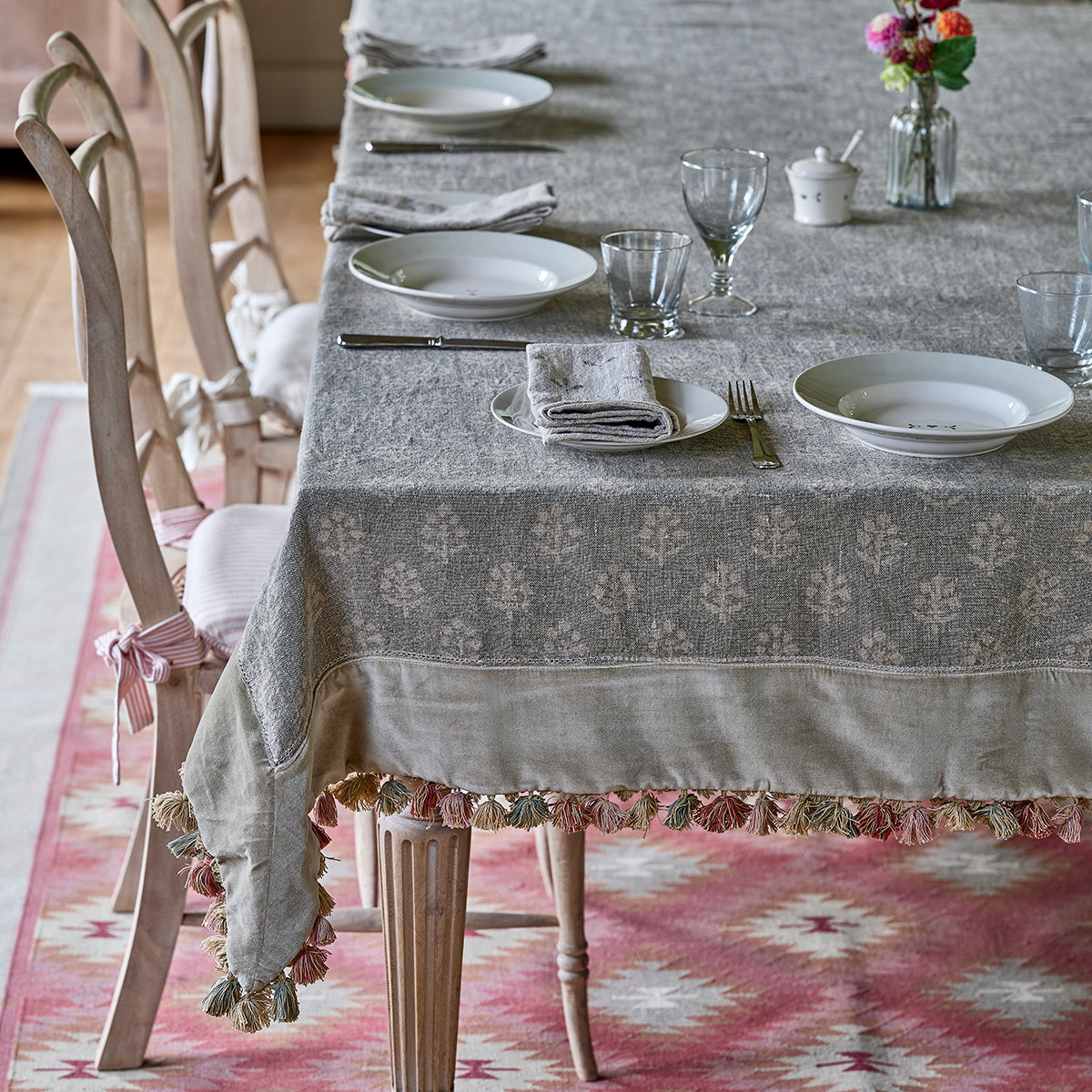 Smokey blue Megha and velvet tasselled tablecloth dressing a long dining table