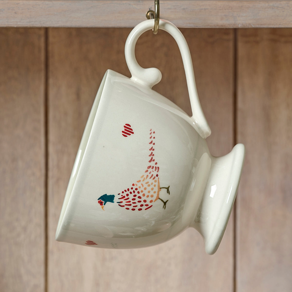 Pheasant large mug tipped on its side against wooden panelling