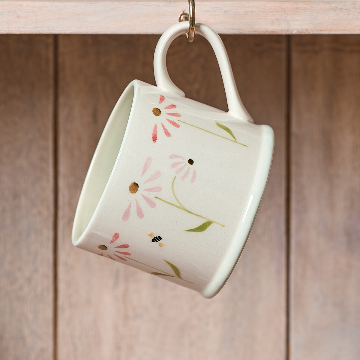 Echinacea straight mug hanging from a hook on wooden panelling