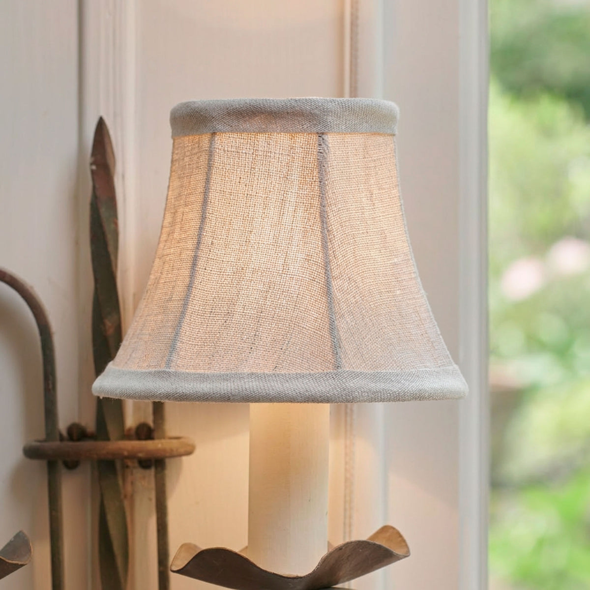 The same framed linen shade lit, casting a warm glow