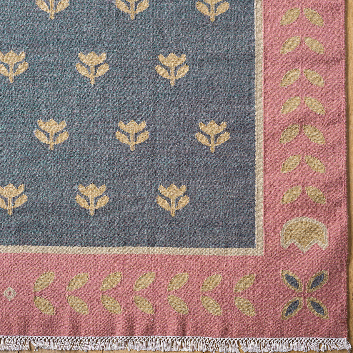 Deep blue kilim corner with gold tulip motifs and patterned border