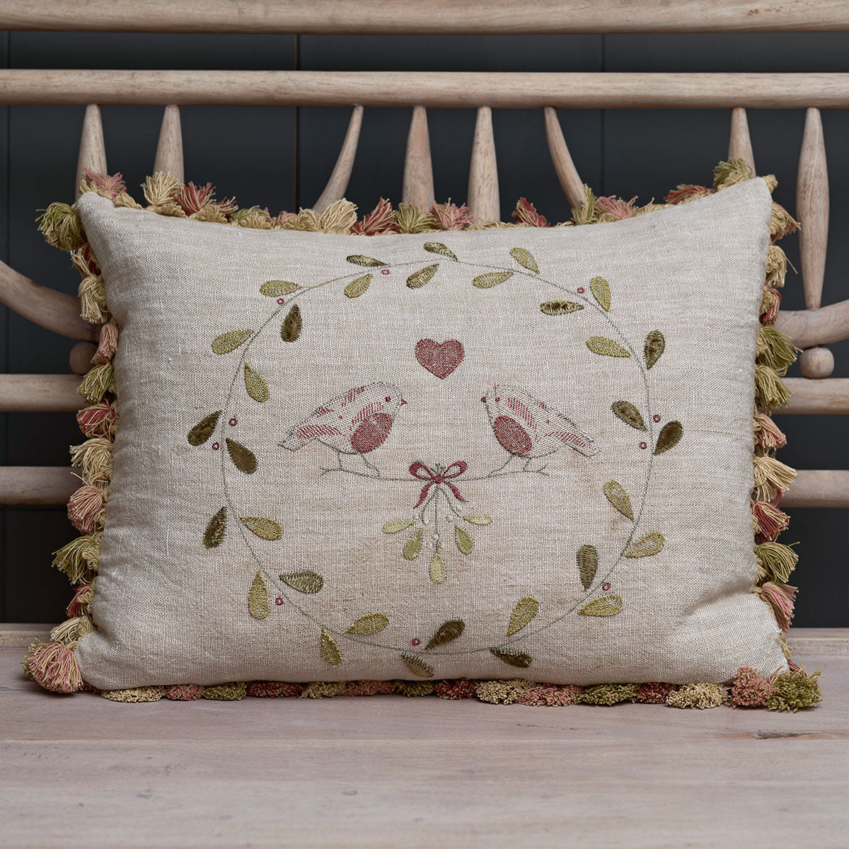 Winter robins cushion embroidered with a mistletoe wreath and heart, tassel trim