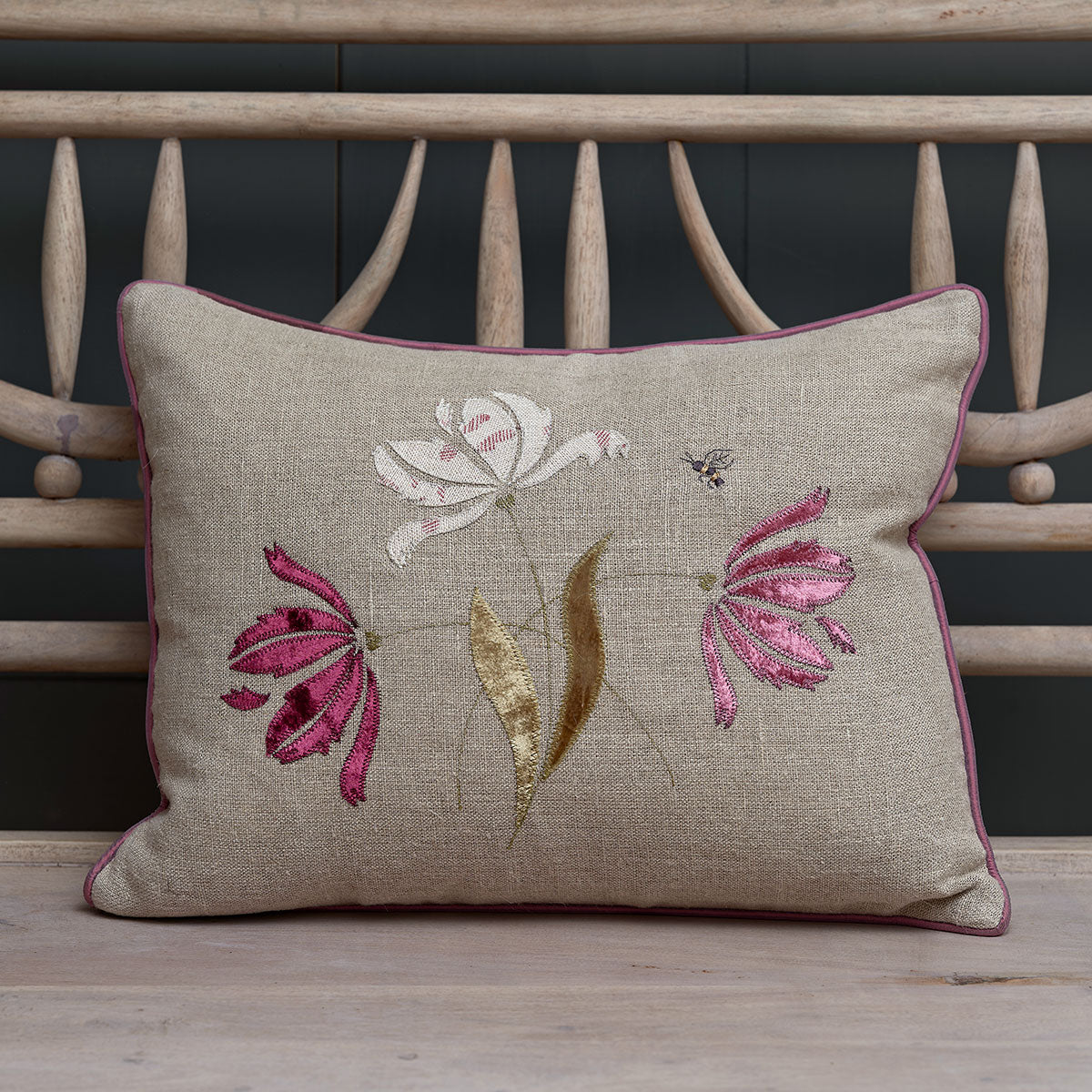 Parrot Tulips rustic linen cushion with pink velvet appliqué tulips on a bench