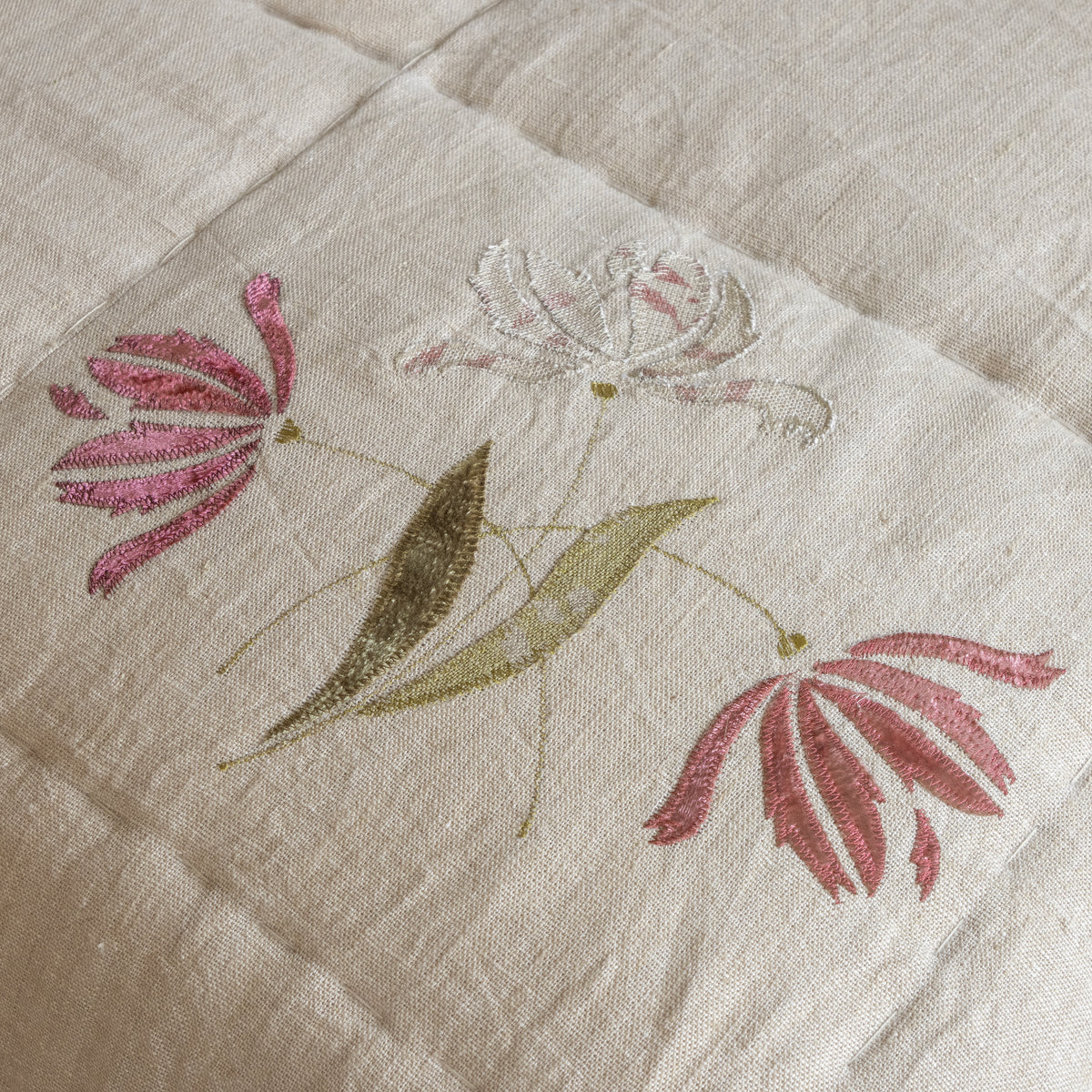 Close view of the embroidered parrot tulip and quilted stitching