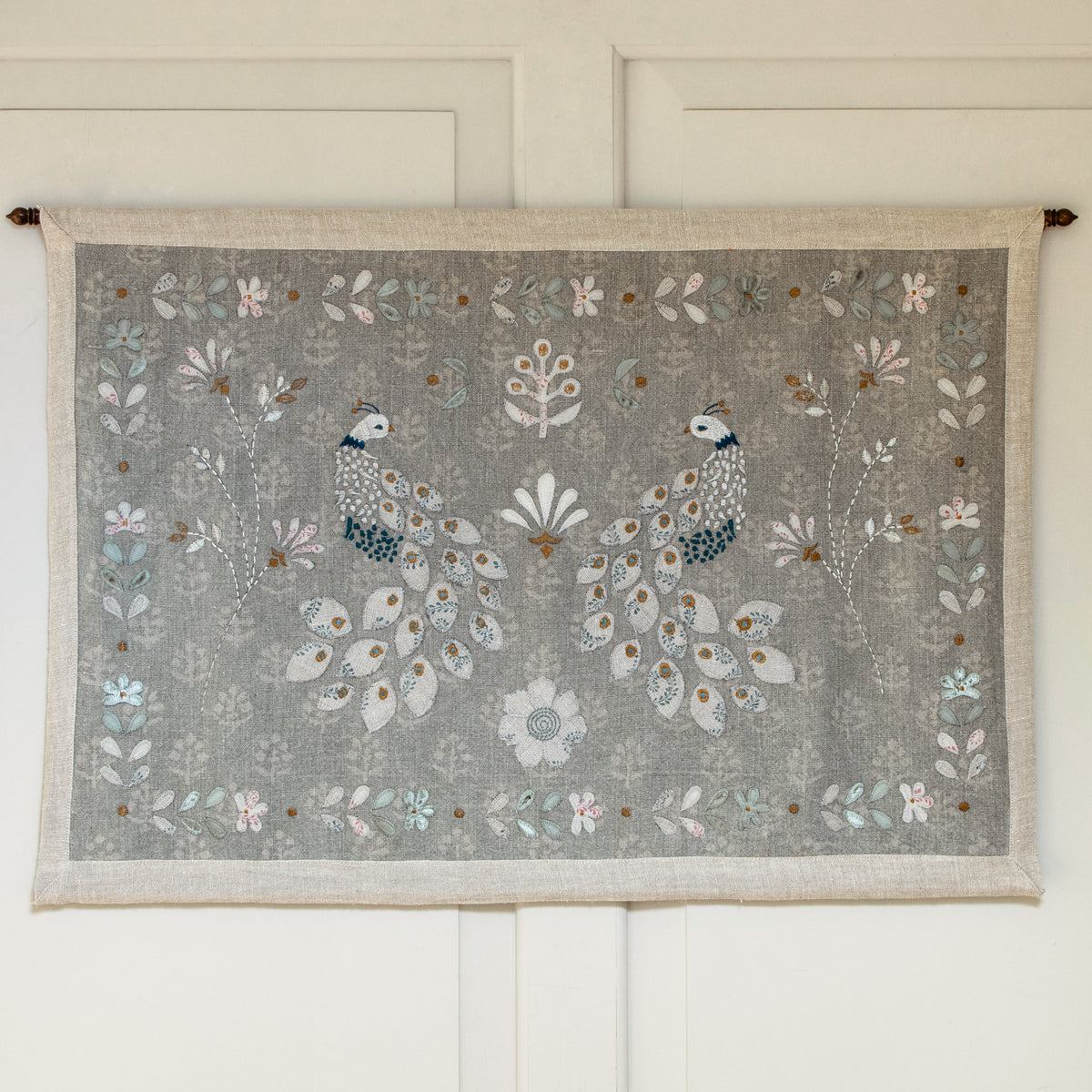 Chinoiserie of Peacocks wall hanging with brass pole on a panelled wall