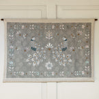 Chinoiserie of Peacocks wall hanging with brass pole on a panelled wall