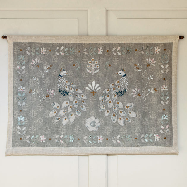 Chinoiserie of Peacocks wall hanging with brass pole on a panelled wall