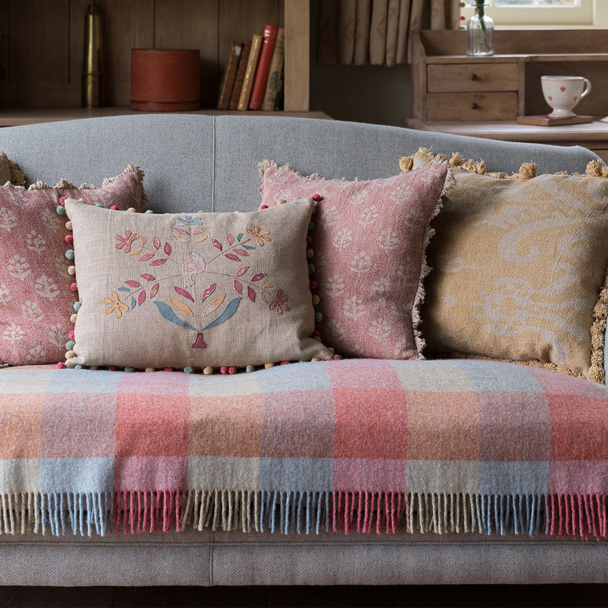 Daisy Tree cushion on a daybed with a pink checked wool throw