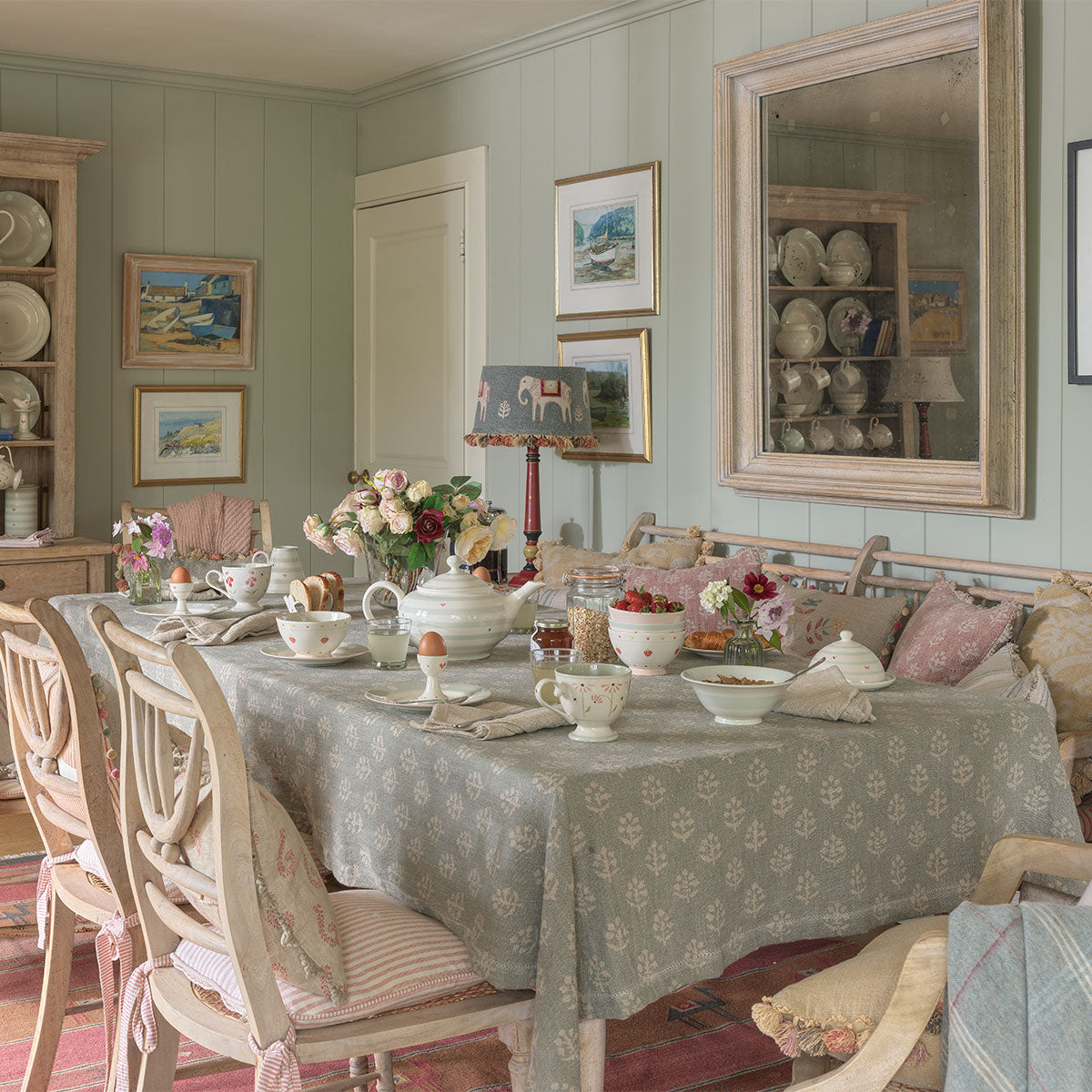 Megha rustic linen tablecloth on a long table in a green panelled dining room