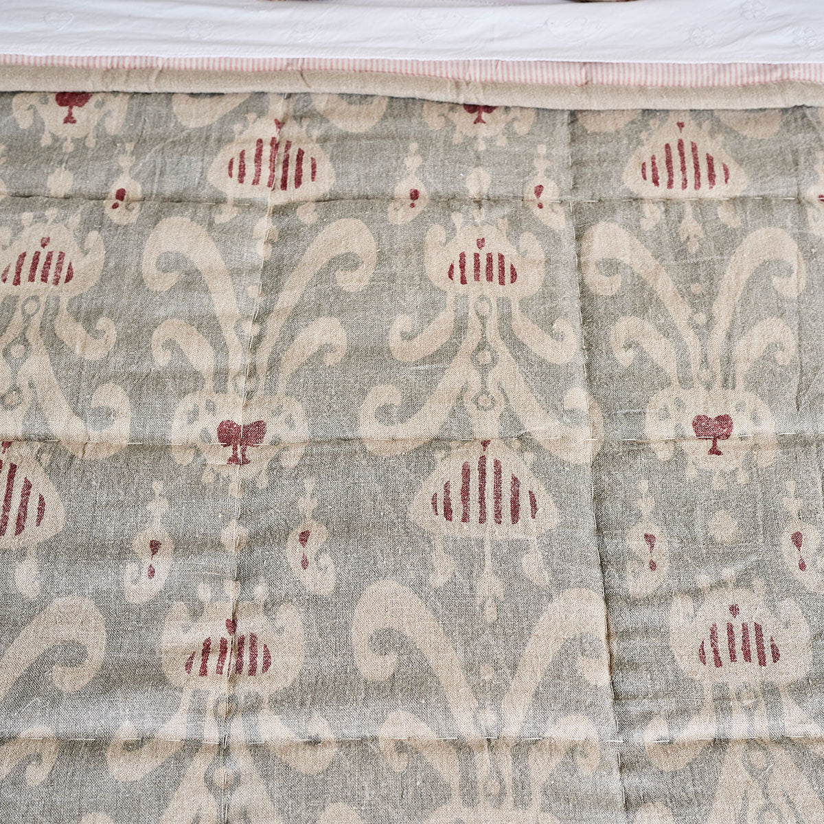 Natasha ikat print in smokey blue and red, close view on linen