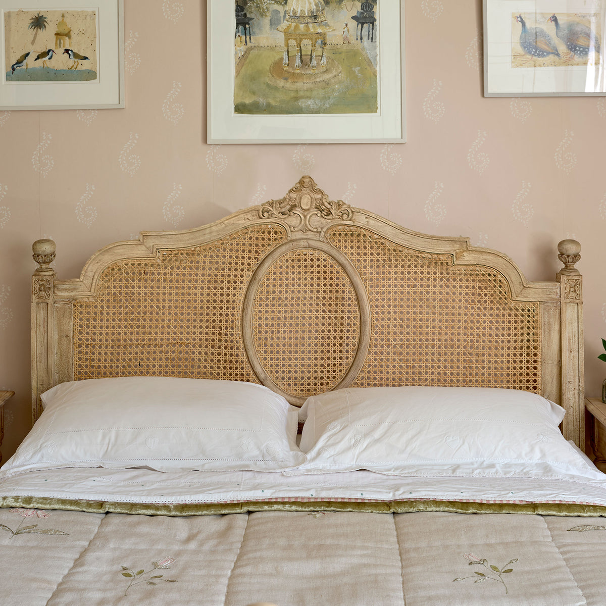 Caned Gustavian bed with carved headboard, white bedding and quilted throw