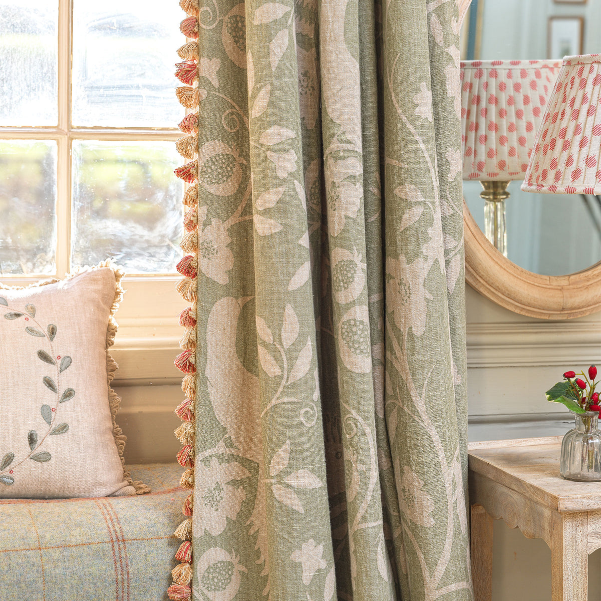 Celadon Hoopoe curtains with tassel trim beside a cushioned window seat
