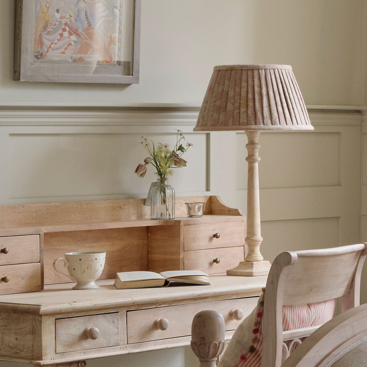 Natasha pleated lampshade lit on a painted dressing table