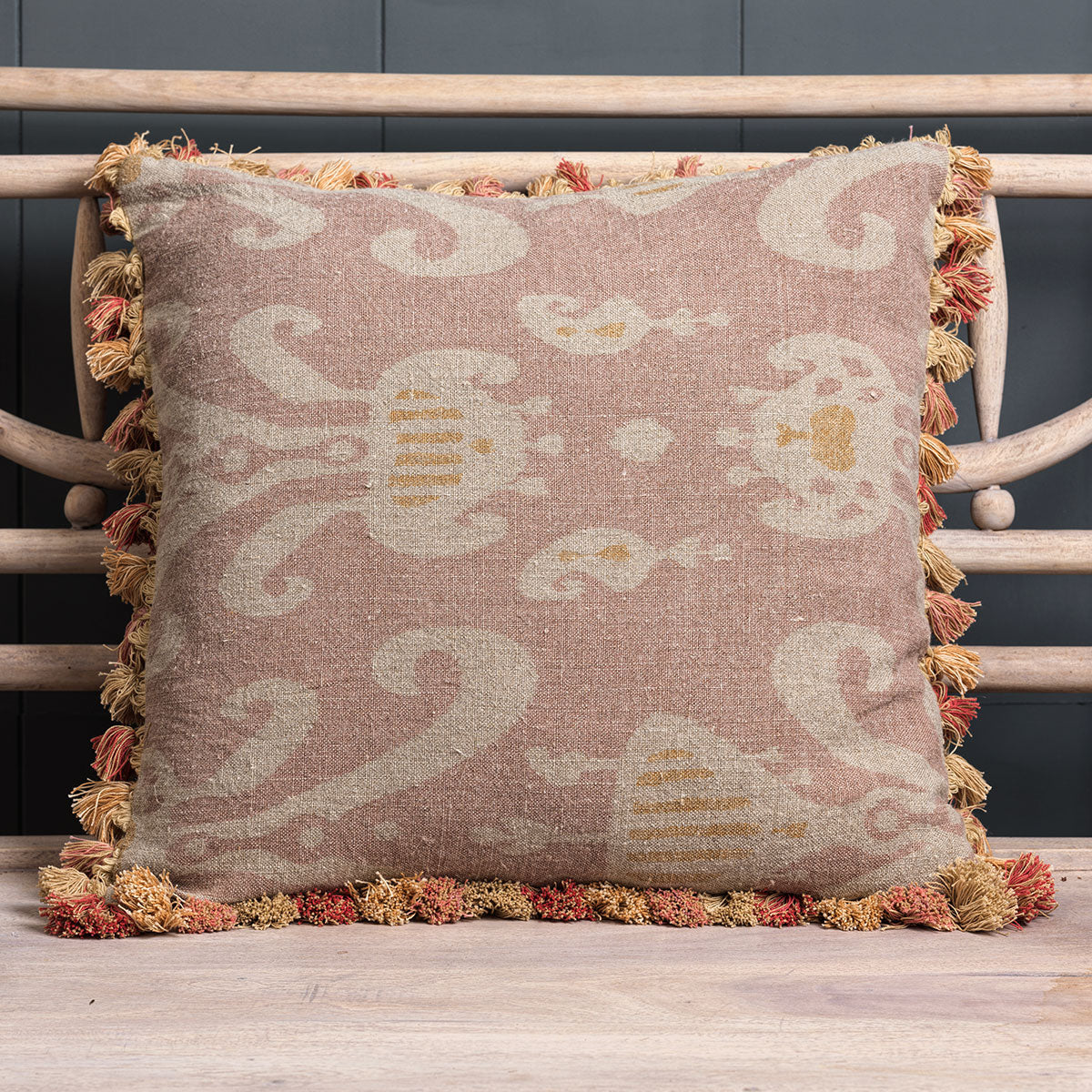 Dusky Pink Natasha rustic linen cushion with tassel trim on a chair