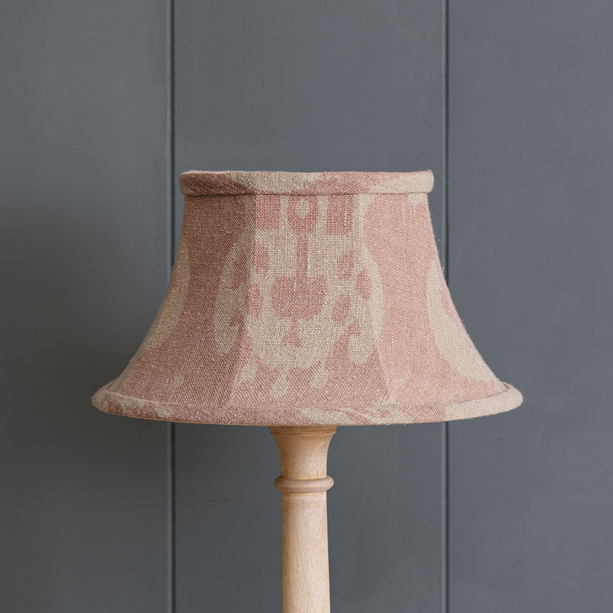 Dusky pink Sacha framed linen lampshade unlit against grey panelling