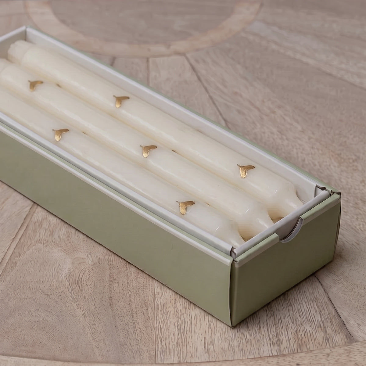 Gold heart dinner candles lined up in their gift box