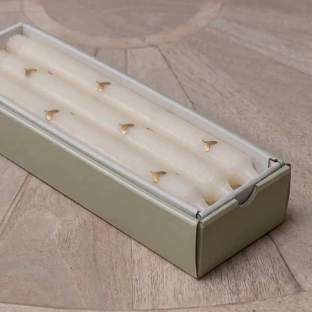 Gold heart dinner candles lined up in their gift box