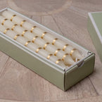 Gold thin stripe hand-painted candles laid in their green presentation box