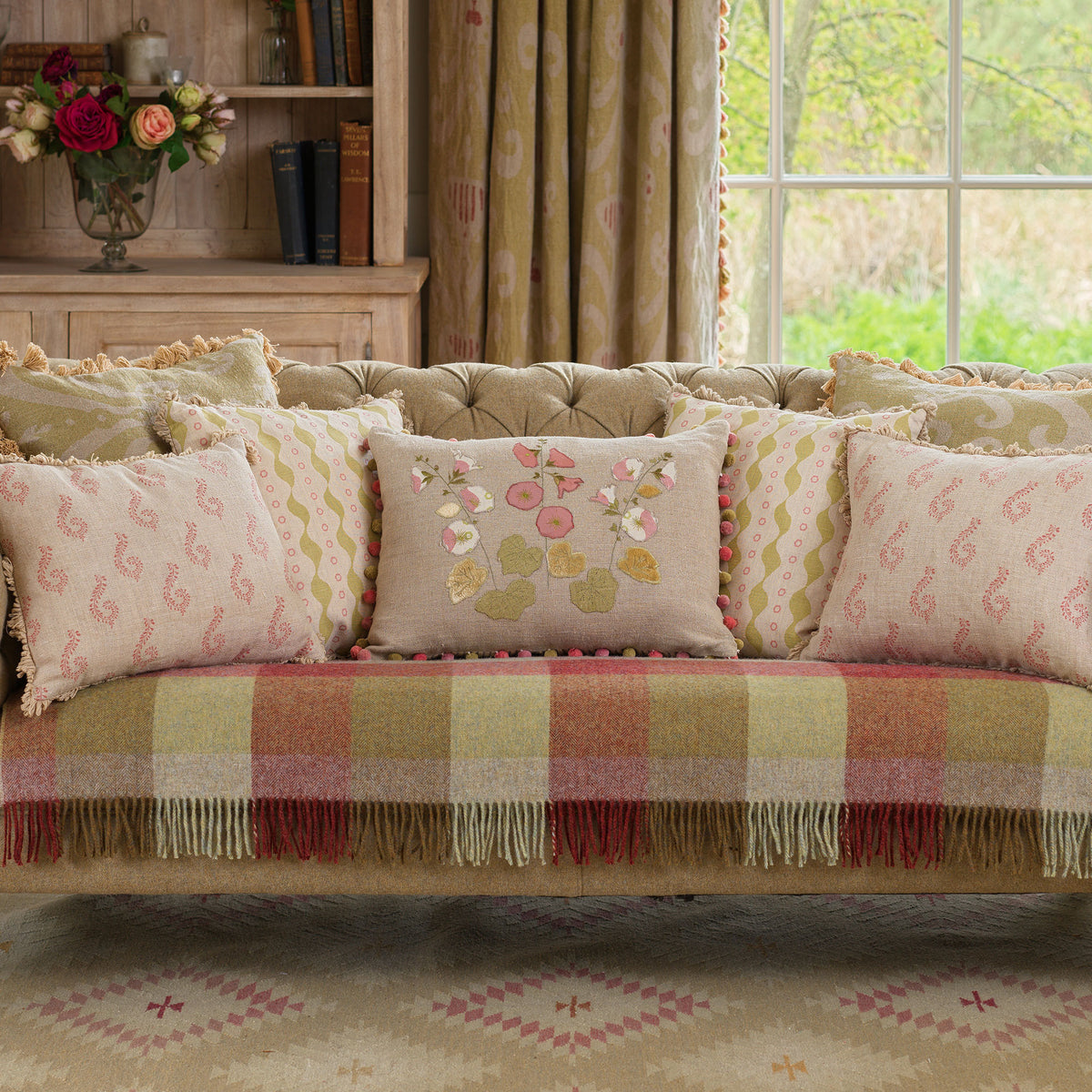 Sofa with Bloomsbury cushions and a pink checked wool throw