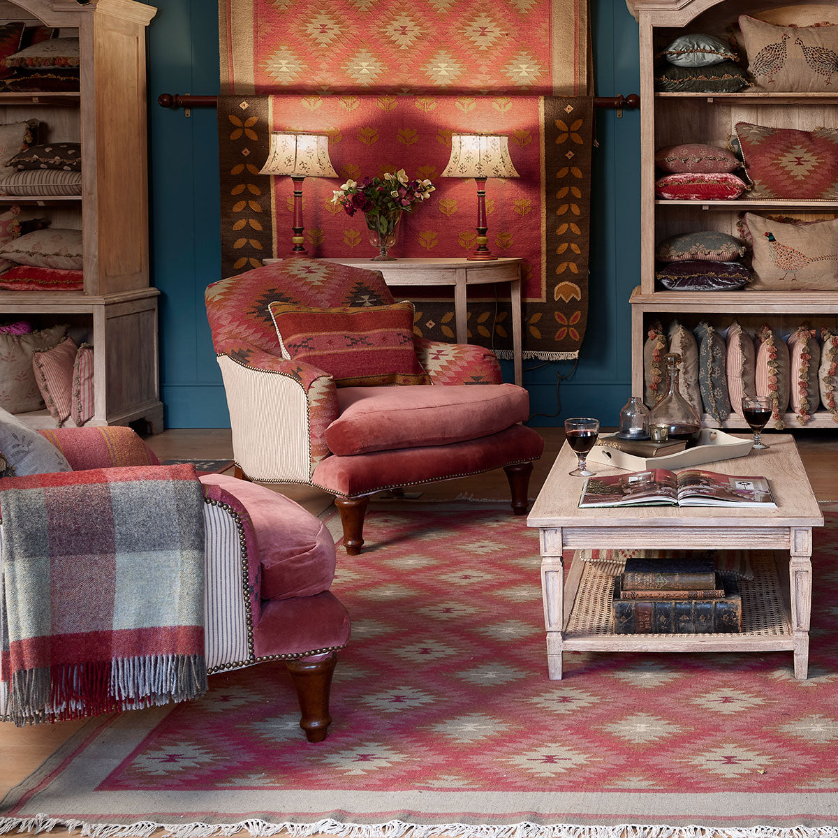 Howard chairs in a sitting room with a kilim rug and checked throw