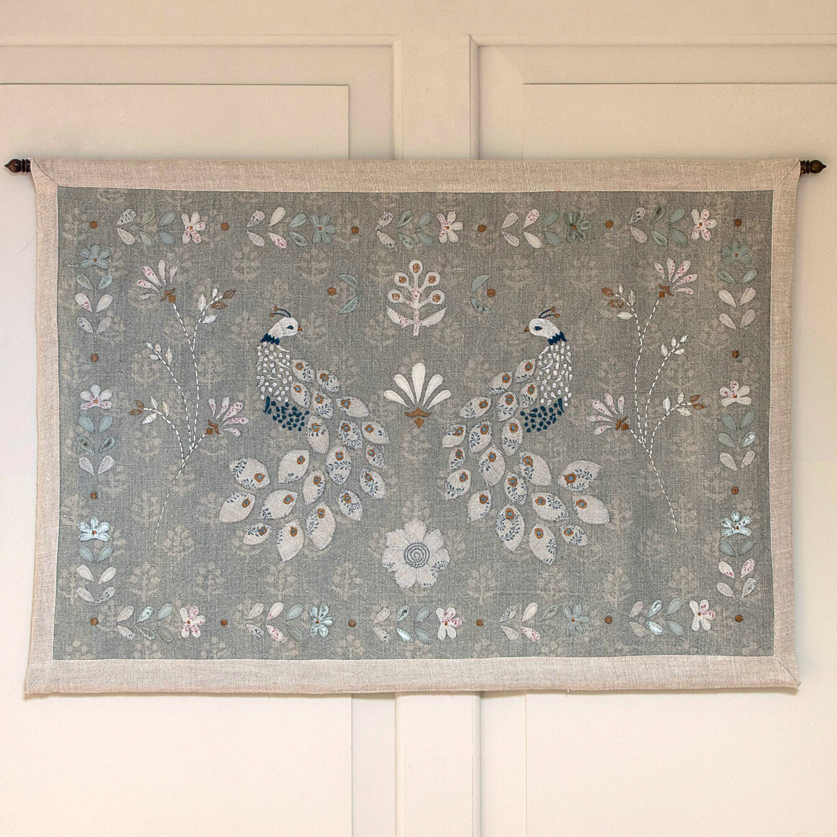 Chinoiserie of Peacocks wall hanging with brass pole on a panelled wall