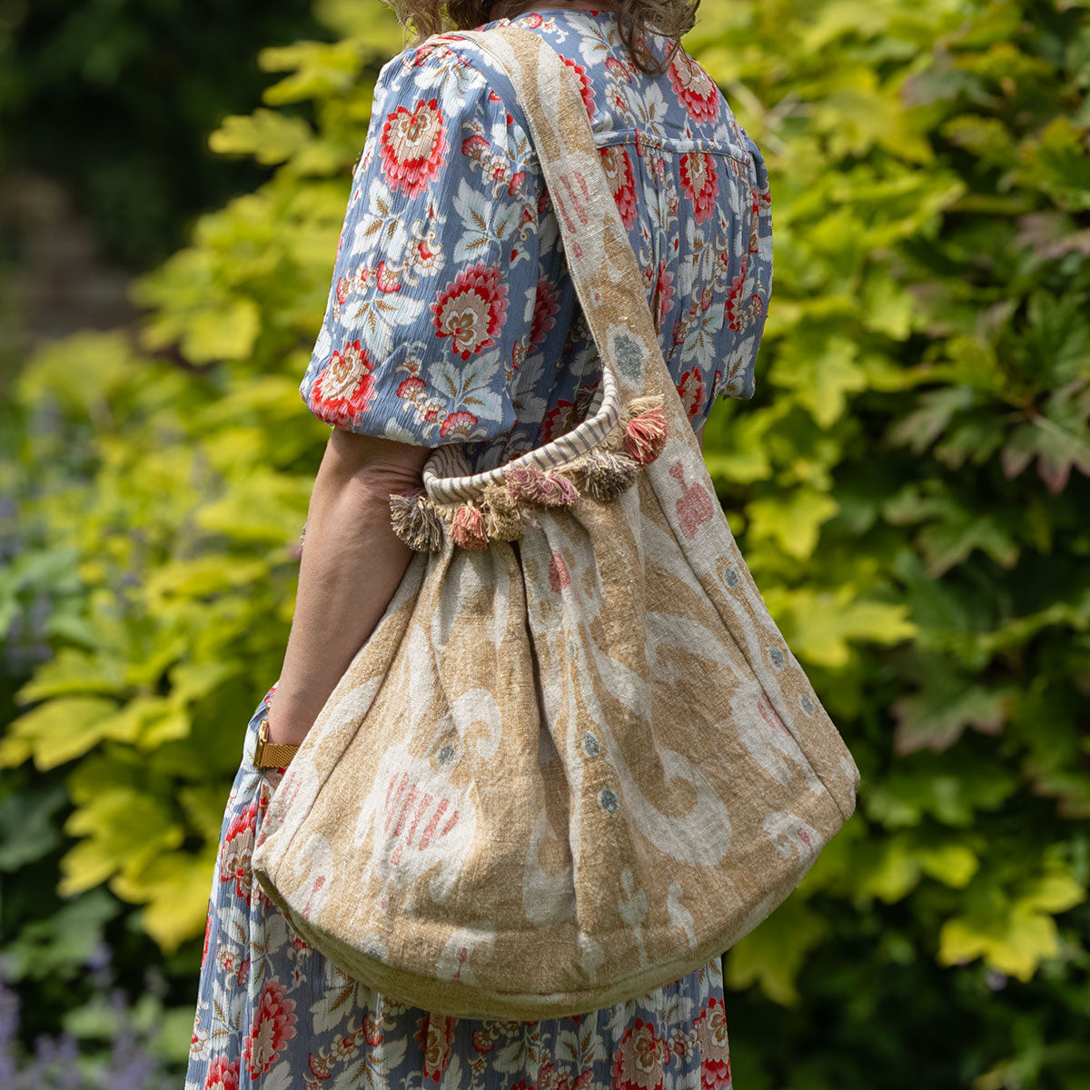 Saffron Natasha slouch bag worn with a blue printed dress outdoors