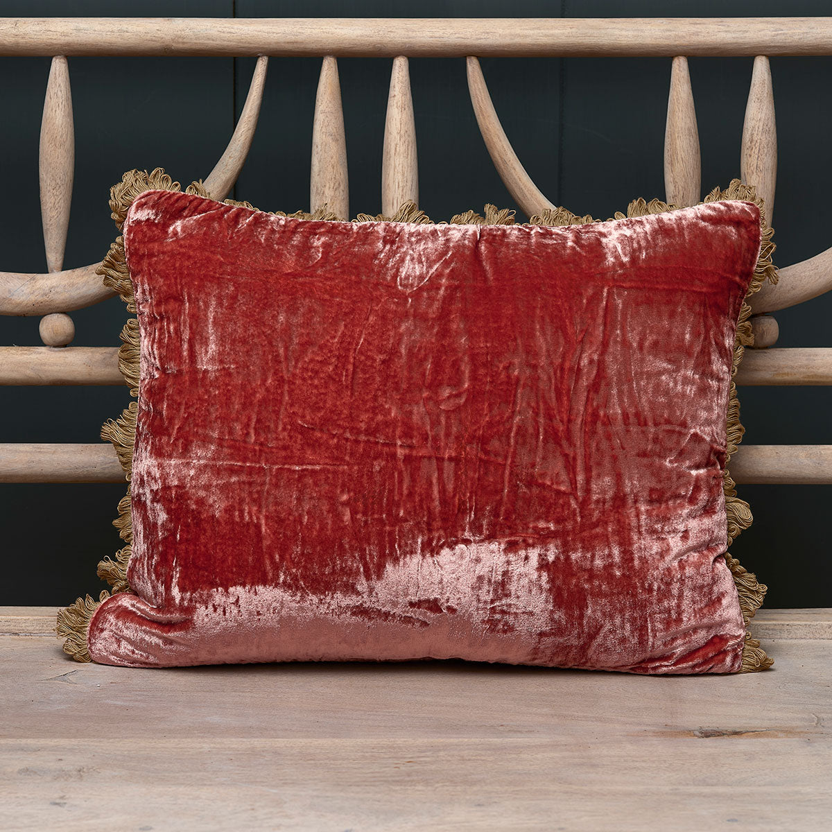 Russet crushed velvet cushion with fan edge trim on a painted bench