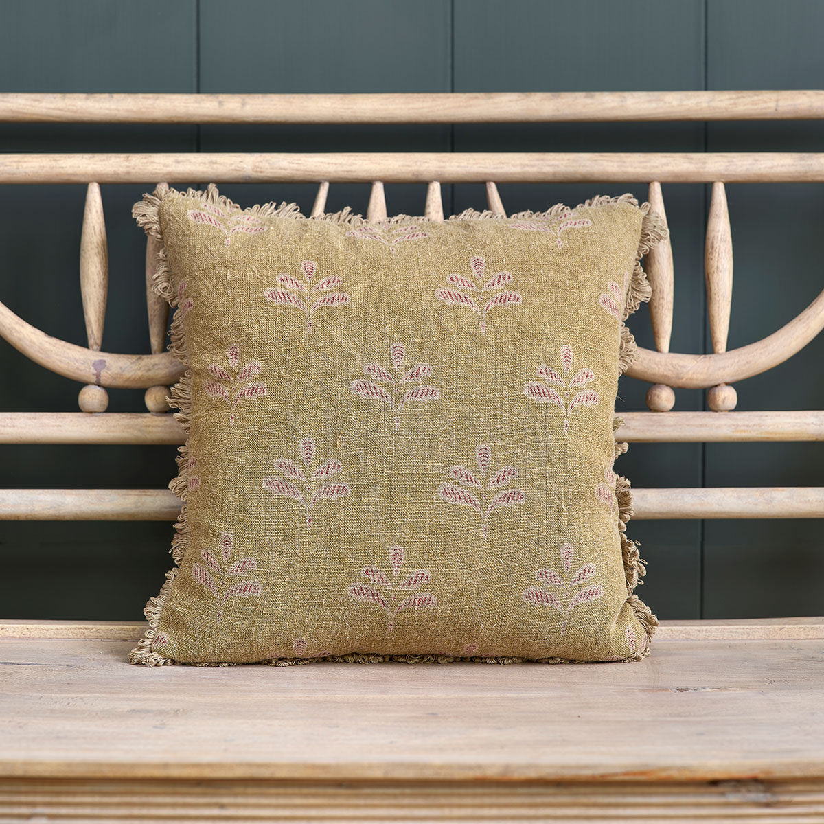 Summer Green Reverse Leaf linen cushion with fringed edge on a bench