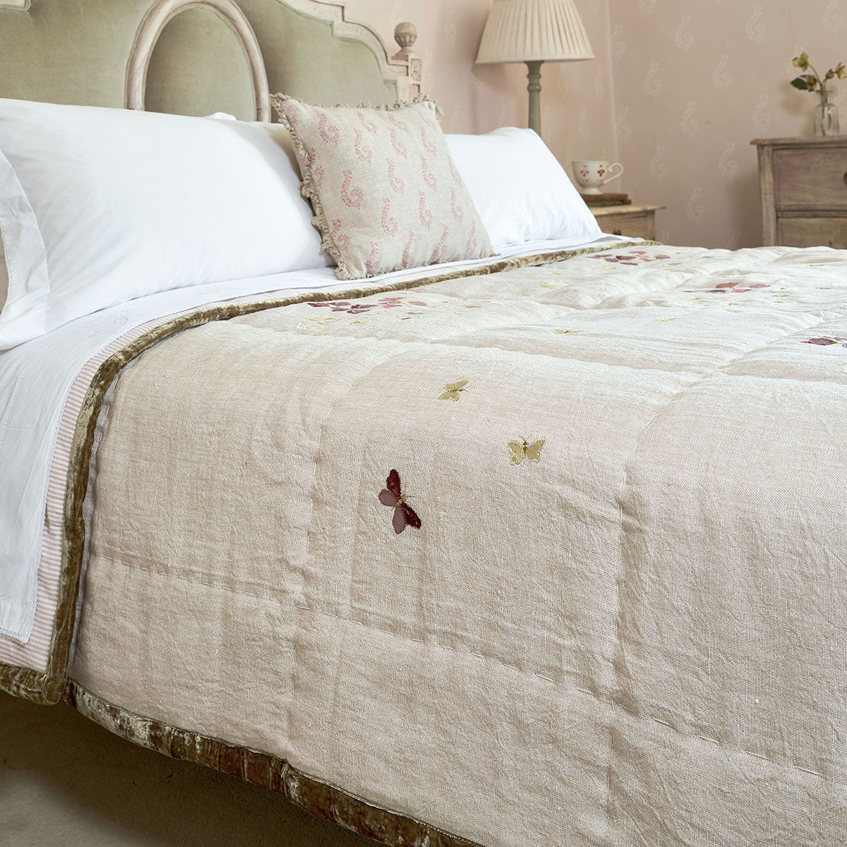 Sweet Pea rustic linen quilt folded across a bed with white pillows