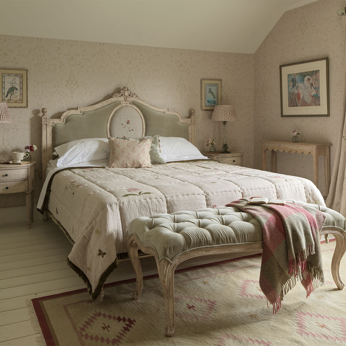 Attic bedroom with the upholstered Gustavian bed and a folded throw