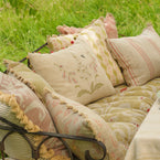 Foxgloves cushions piled on a garden seat in bright sunlight