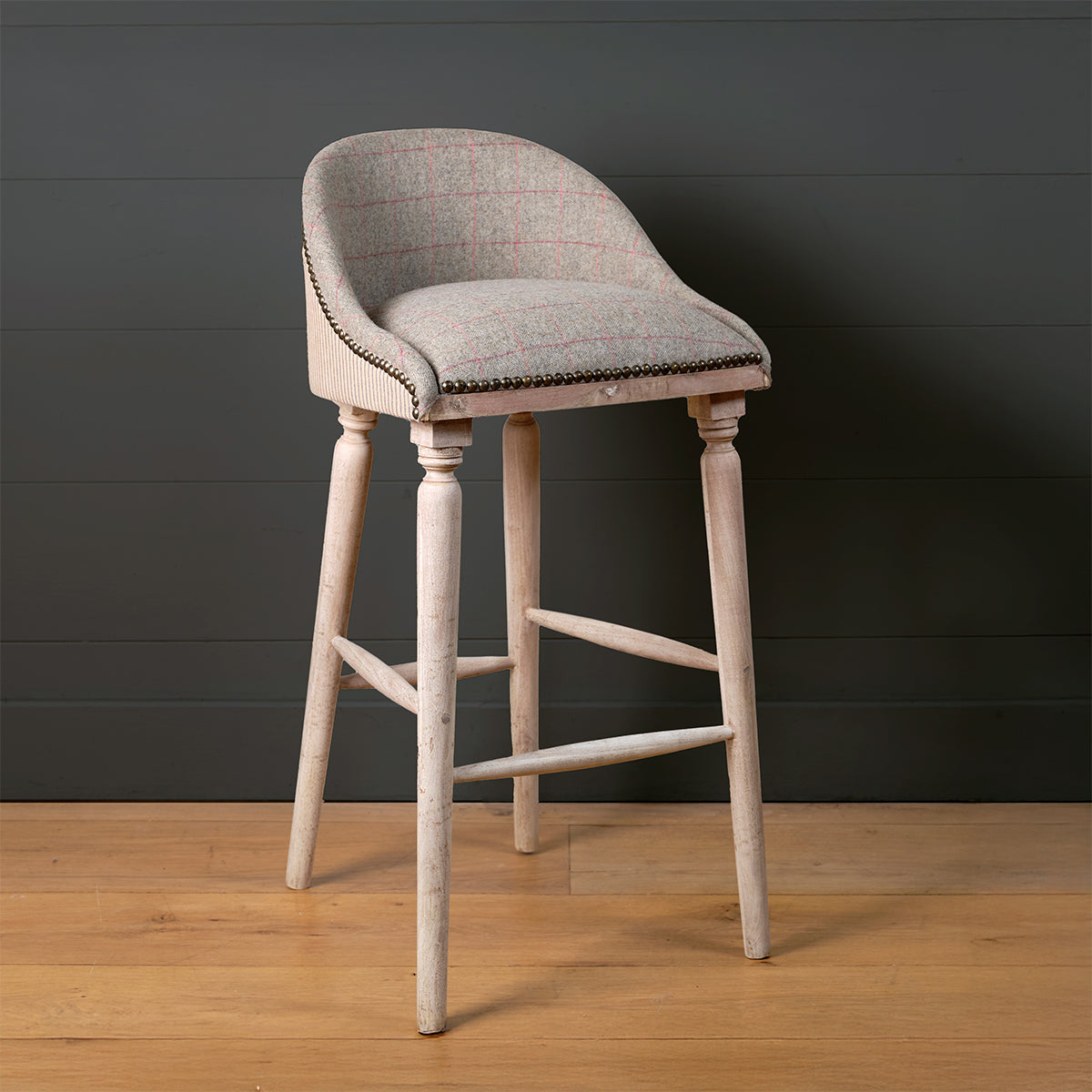Bar stool in plain pale grey linen with studded trim