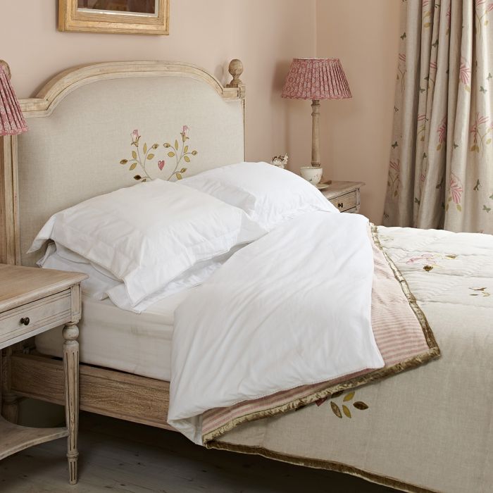 Duck egg spot duvet on a painted bed with pink pleated lampshade