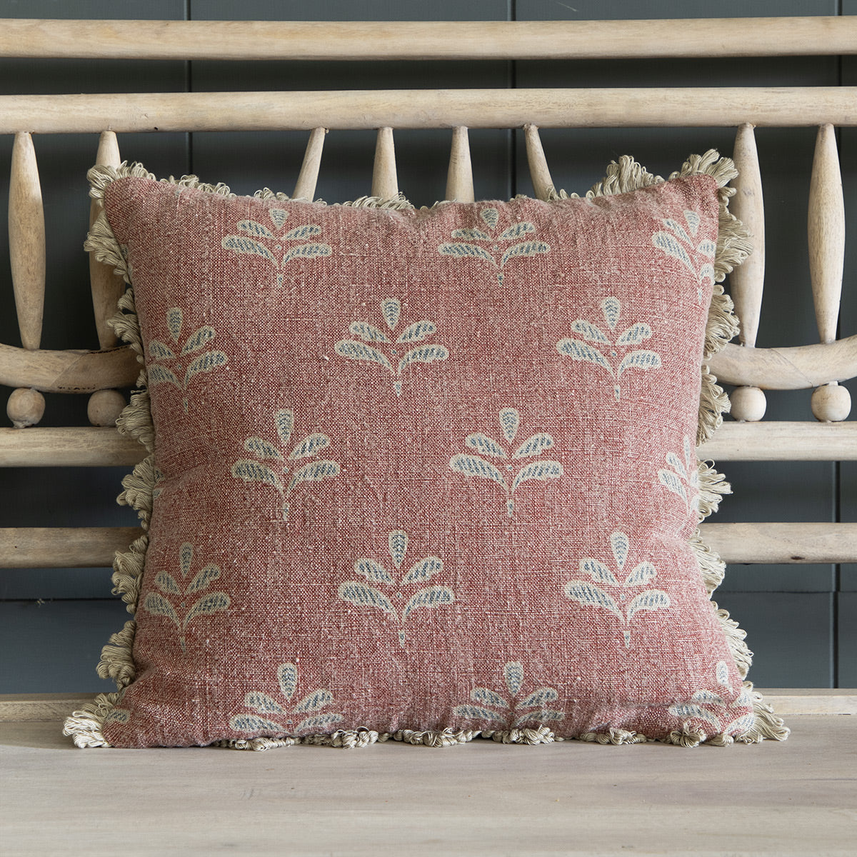 Red Earth Reverse Leaf rustic linen cushion with fan edge trim on a bench