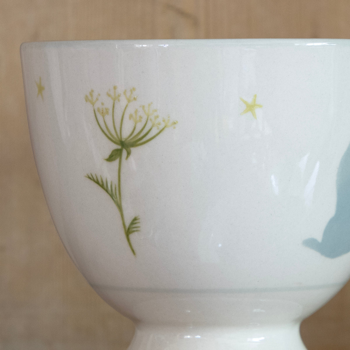 Close view of the hand-painted seed heads on the mug's side