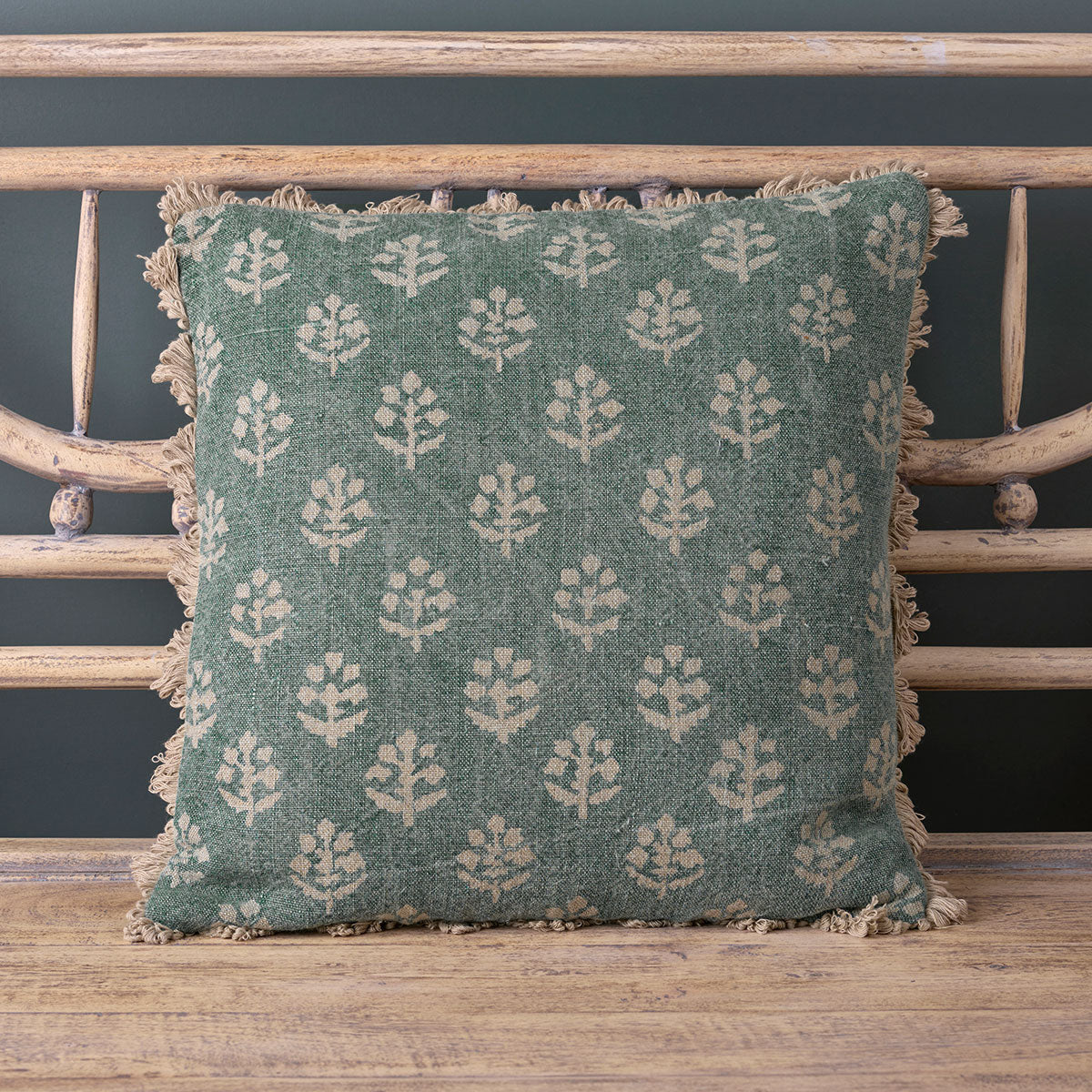 Faded Indigo Megha rustic linen cushion propped on a cane chair