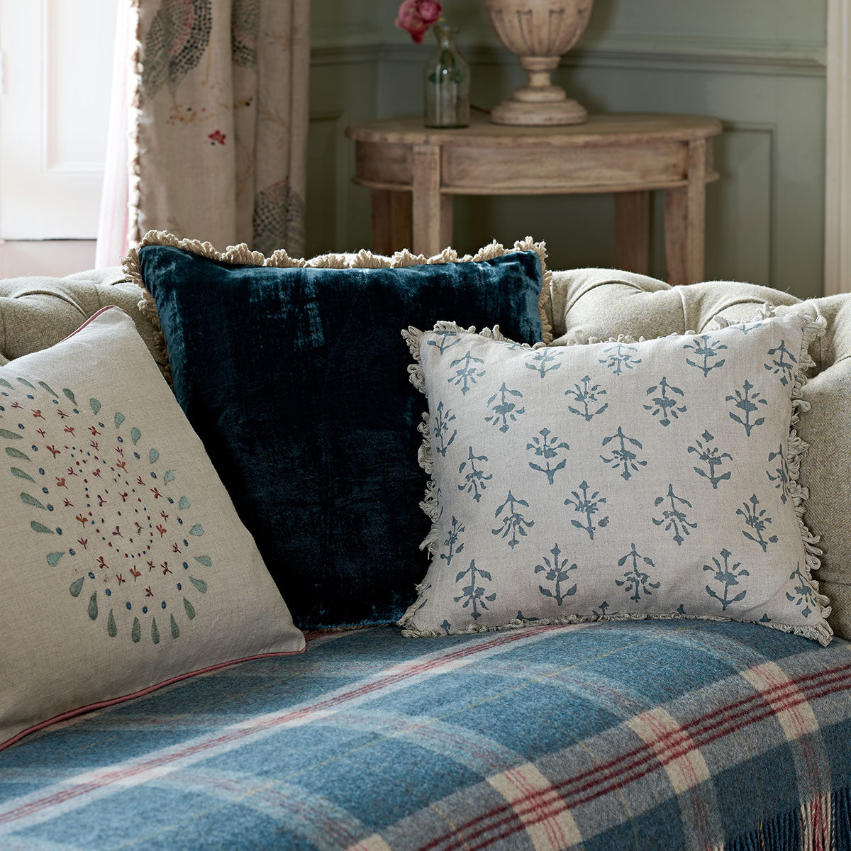 Moonflower cushions with navy velvet on a blue tartan sofa
