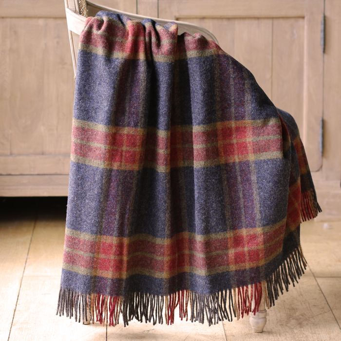 Midnight and Russet tartan Shetland wool throw folded with fringed edge