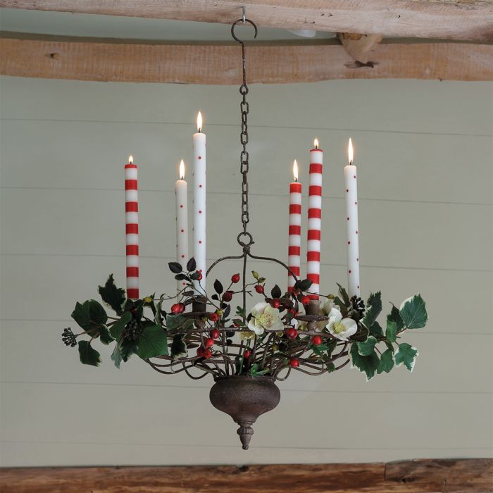 Red spot candles lit in a foliage-dressed hanging chandelier