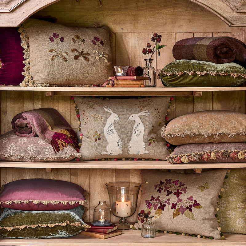 Autumn Hydrangea cushions on a settle beside a dresser and candlelight