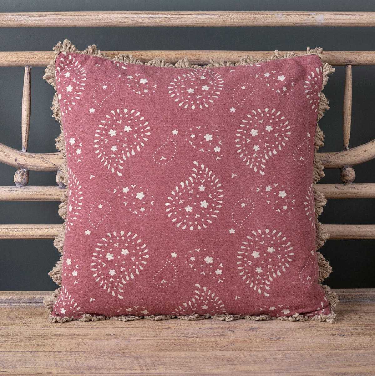 Sail Red Lullaby paisley cushion with fan edge trim on a bench