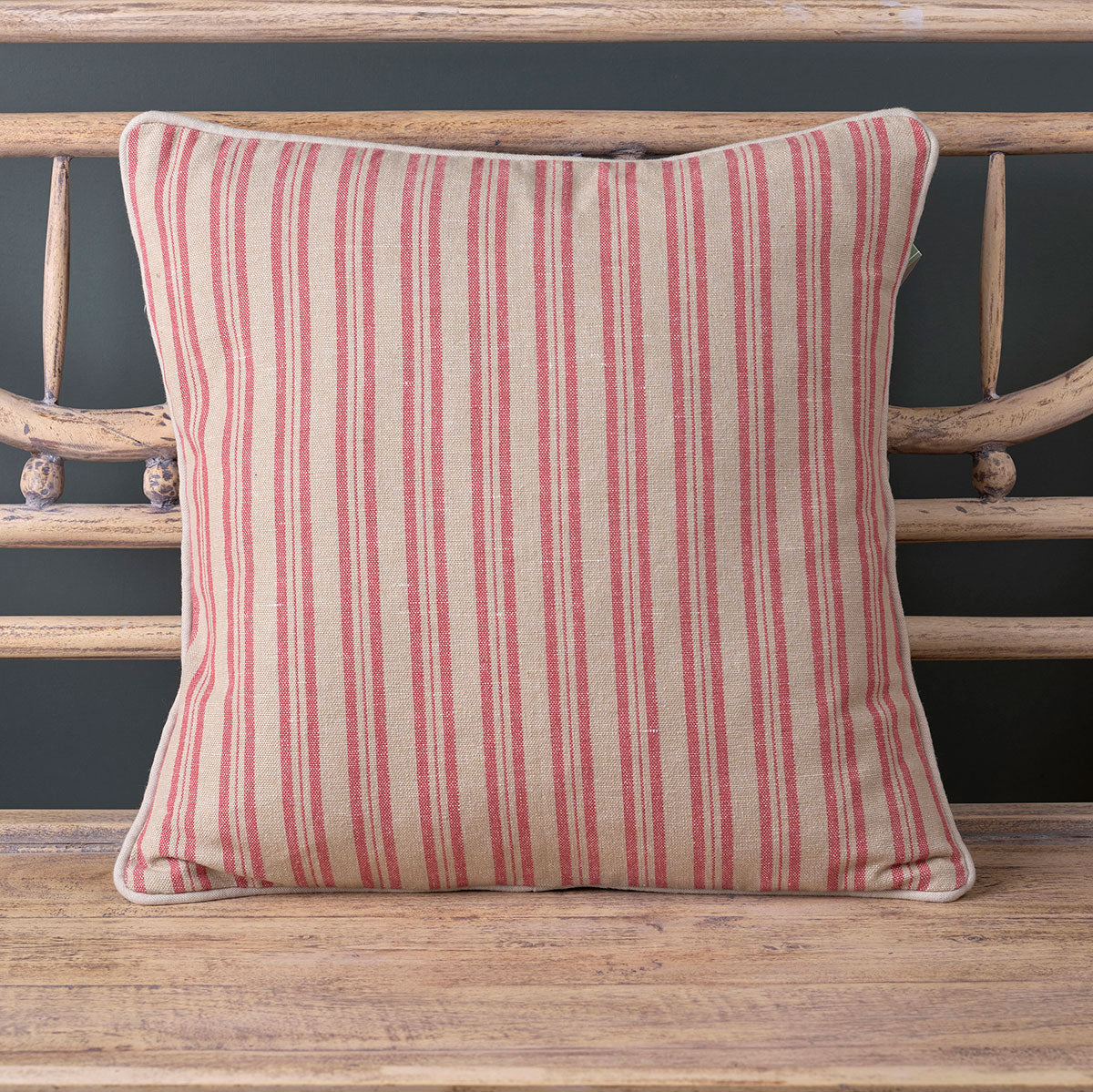 Rusty Rose Beech ticking stripe cushion with piped edge on a bench
