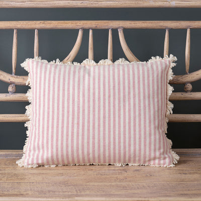 Rose ivory striped cotton cushion with frilled edge on a carved wooden bed