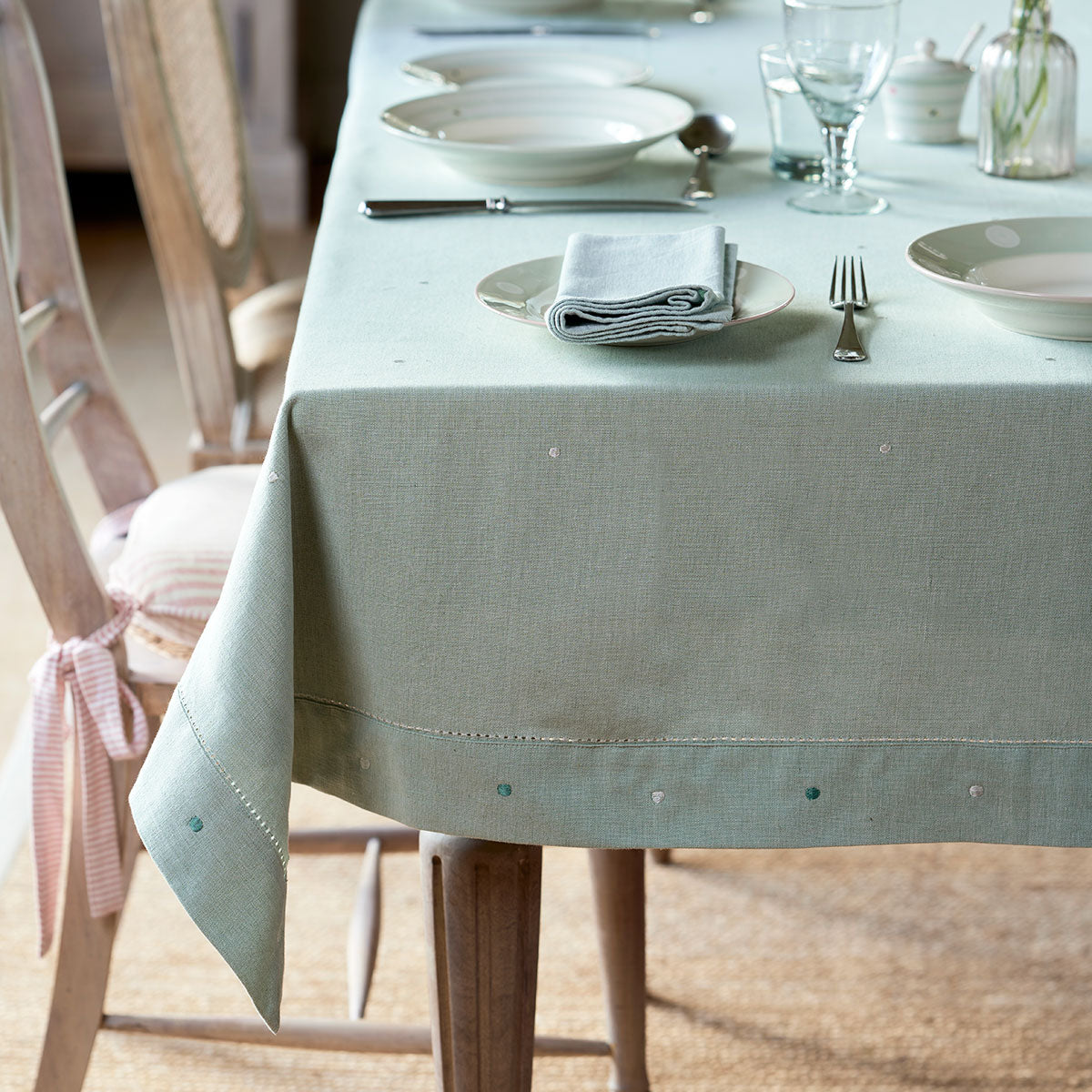 Duck egg white spot tablecloth on a table laid with china