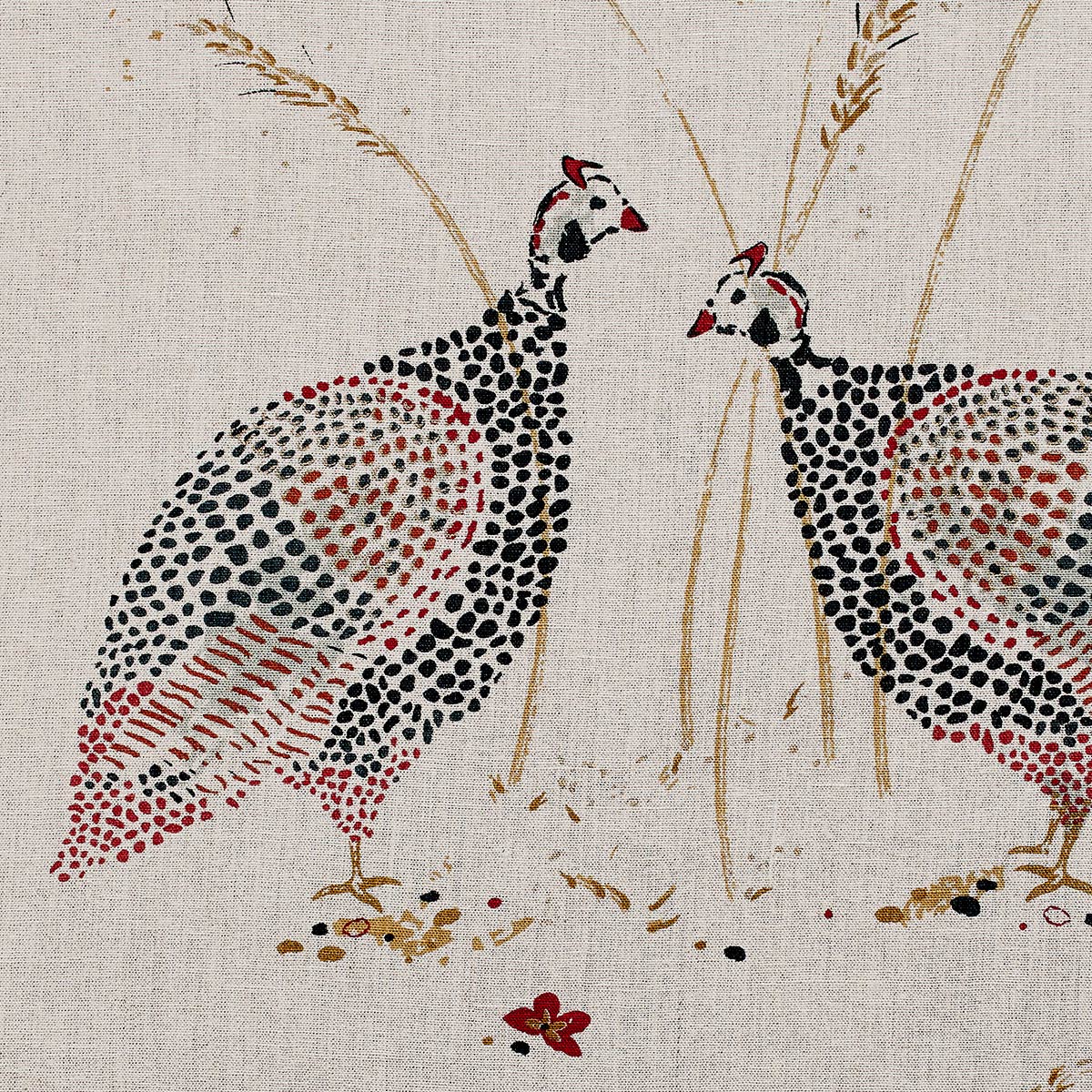 Two printed guinea fowl facing each other on red saffron linen