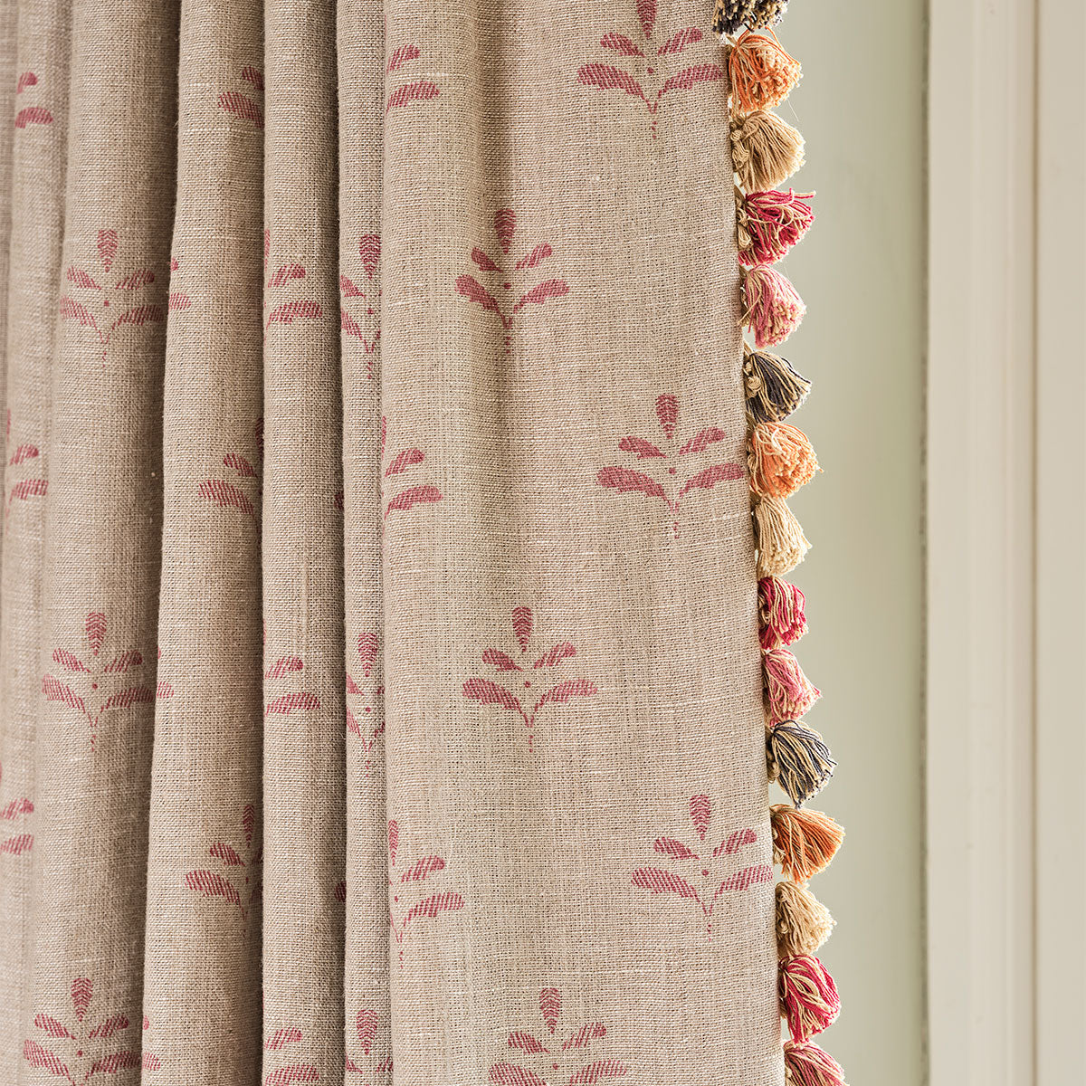 Red Leaf linen curtain edged with orange and pink tassel trim