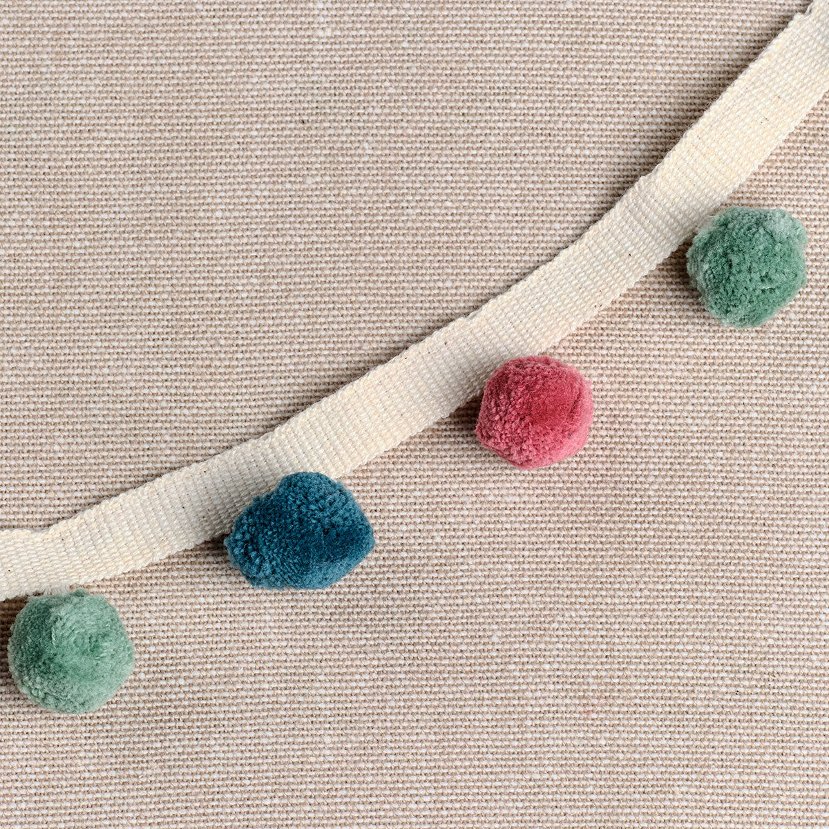 Egyptian Blue, duck egg and rose pompom trim stitched to natural linen