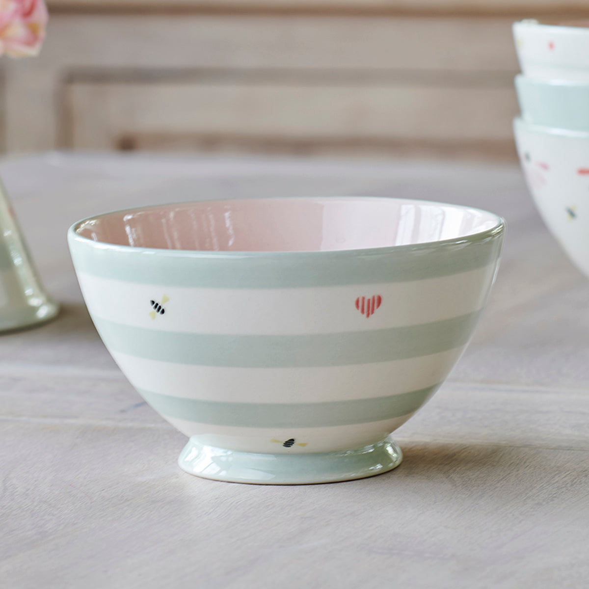 Honey Bees French bowl with sage stripes and painted hearts, plain background