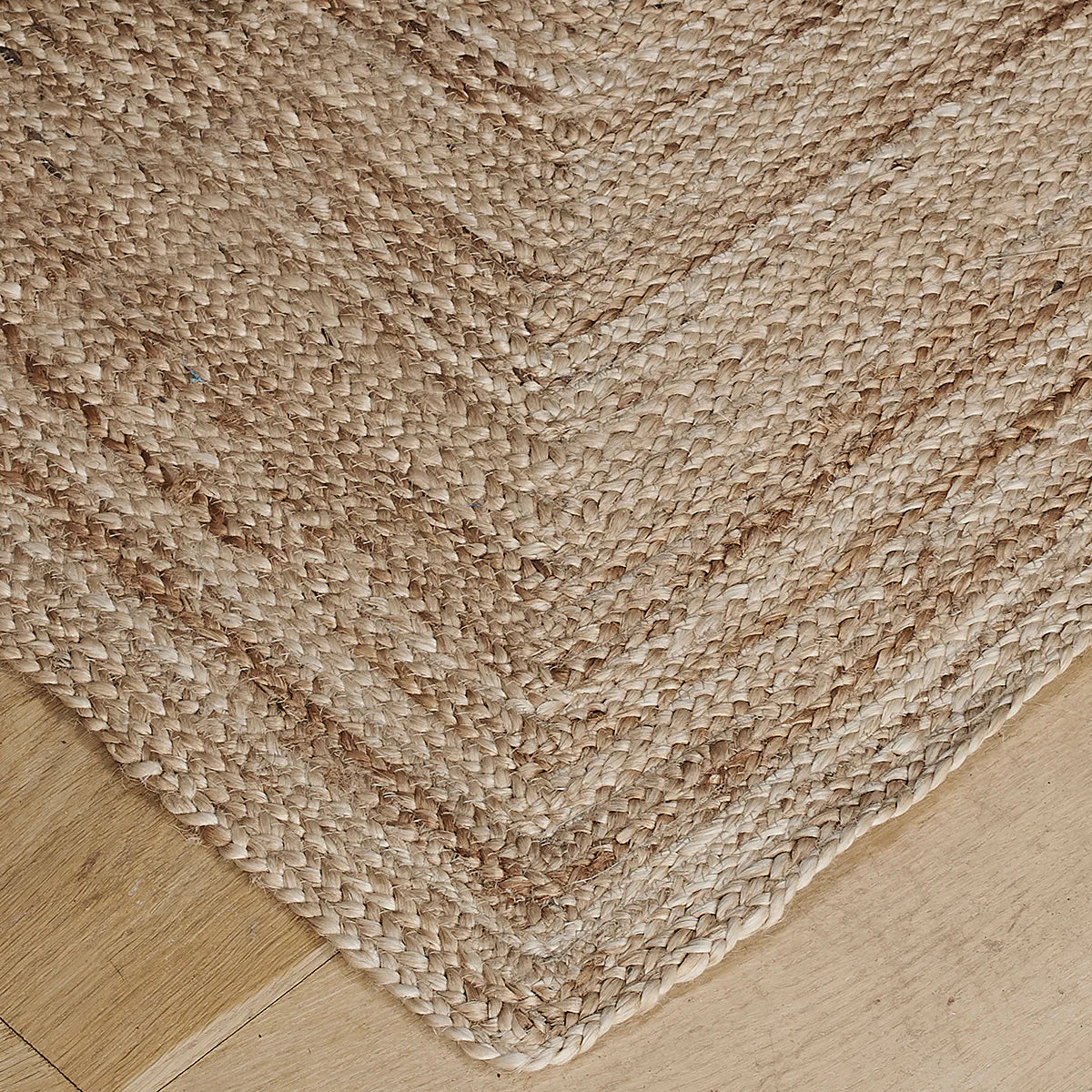 Close view of the woven hemp rug and its mitred border