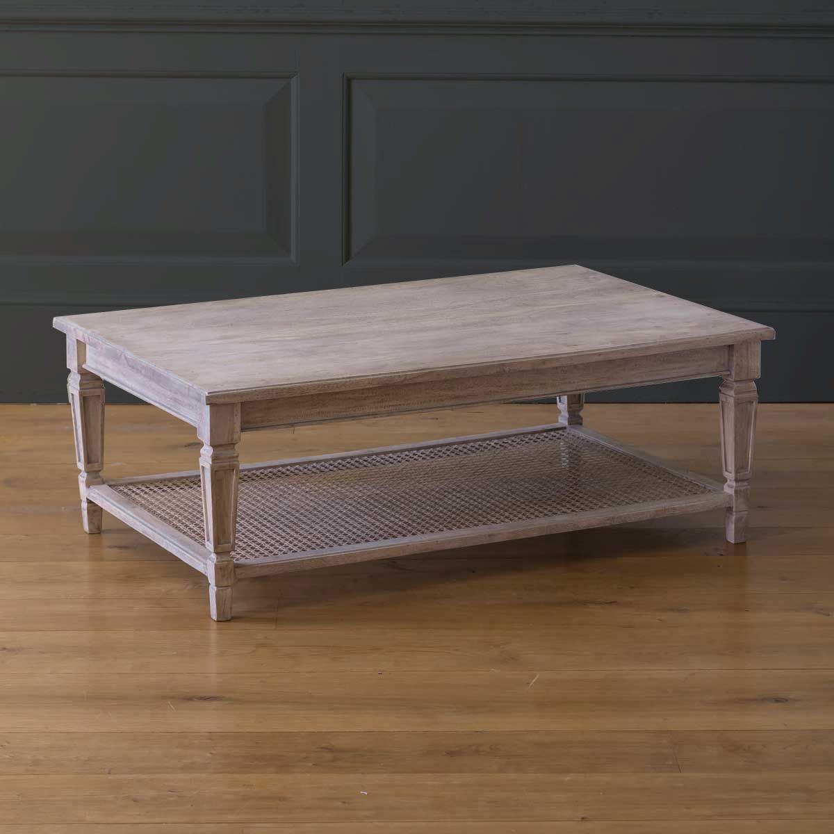 Limed caned coffee table with lower cane shelf, plain studio shot